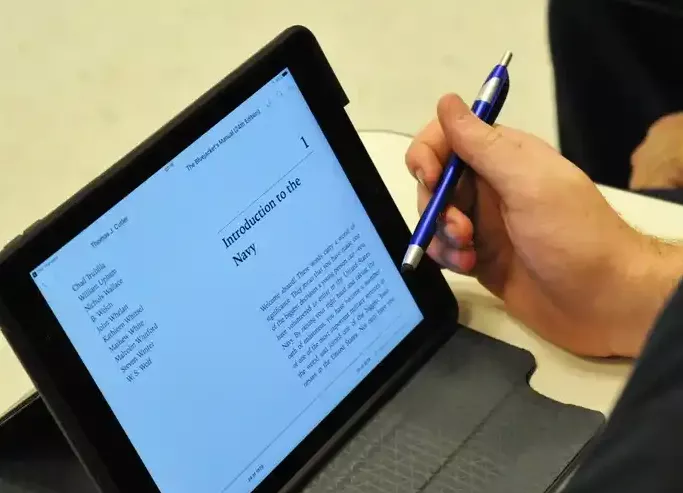 Sailor studied naval history on a tablet.